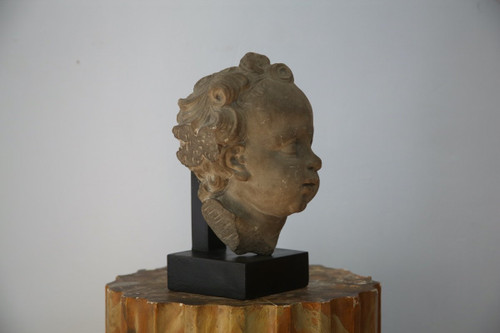 Grey stoneware sculpture of a child's face, Netherlands, early 18th century.