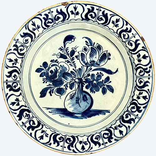 Delft, XVIII Secolo, Piatto Di Terracotta Decorato Con Vaso Bottiglia Fiorito.