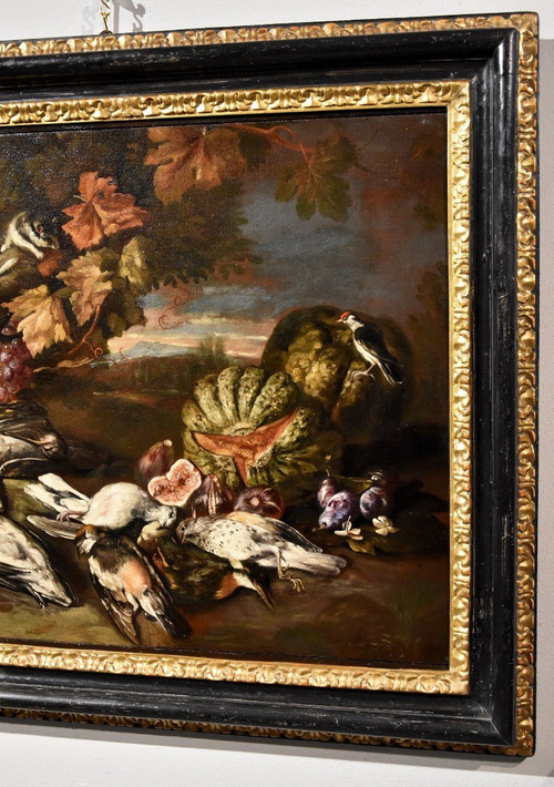 Natura morta in un paesaggio con frutta e cacciagione