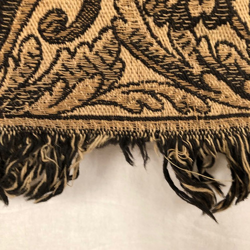 Antique tapestry or table cloth on a black background with rich decorations of Medici vases and flowers