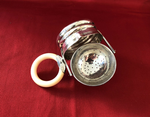 Rocking tea strainer in hallmarked solid silver, ivory handle, late 19th century.