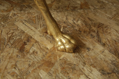 Guéridon tripode en bronze ciselé et doré, travail néoclassique du XXème siècle.