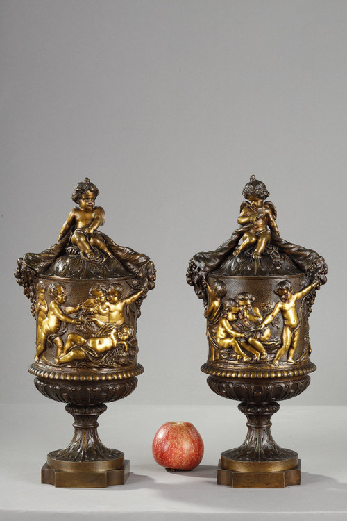 PAIR OF COVERED VASES, IN FINELY CHASED BRONZE WITH A RICH ROTATING DECORATION