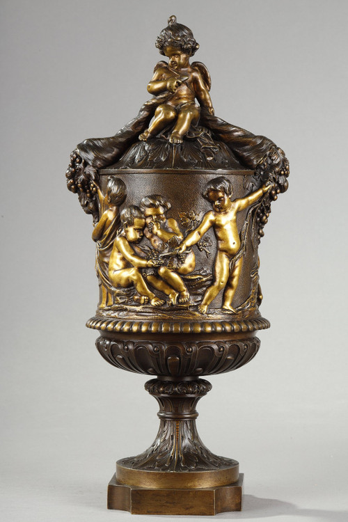 PAIR OF COVERED VASES, IN FINELY CHASED BRONZE WITH A RICH ROTATING DECORATION