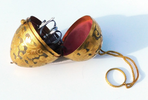 Miniature steel sewing kit in a golden metal egg-shaped box