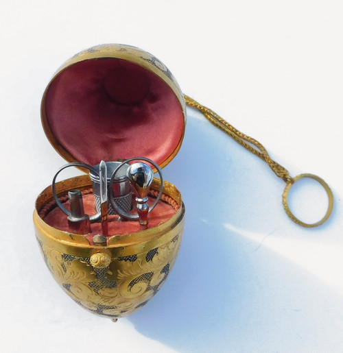 Miniature steel sewing kit in a golden metal egg-shaped box