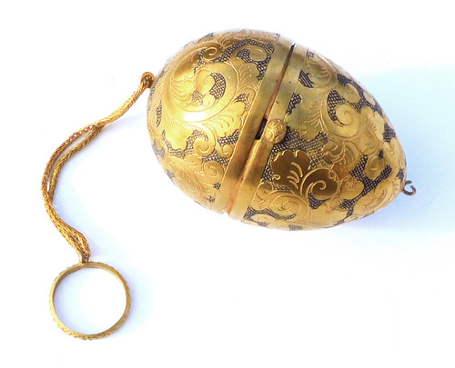 Miniature steel sewing kit in a golden metal egg-shaped box