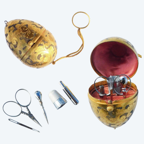 Miniature steel sewing kit in a golden metal egg-shaped box