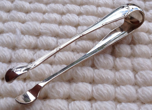 Silver metal sugar tongs model Ribbons goldsmith Christofle