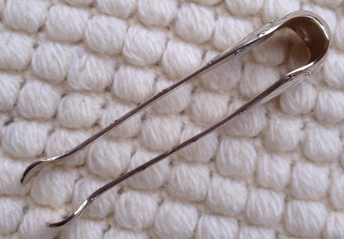 Silver metal sugar tongs model Ribbons goldsmith Christofle