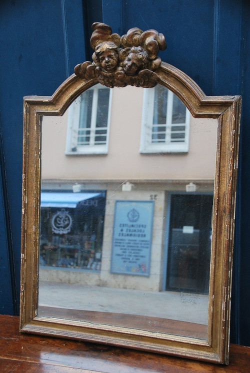 Specchio in legno dorato con teste d'angelo, XVIII secolo