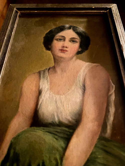 Jeune Femme à la chevelure brune assise se tenant le genoux faisant la pose dans sa jupe verte 1930