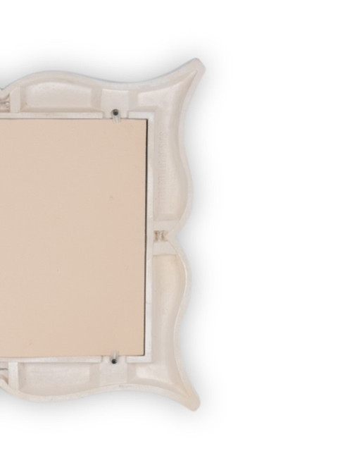 Art Deco style stucco mirror in “mustache” shape. 1990s.