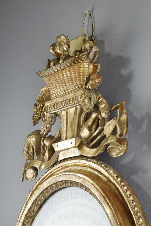 Barometer-thermometer in gilt wood, Louis XVI period