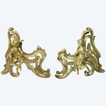 Pair of Louis XV style gilt bronze andirons representing a couple seated on rockery