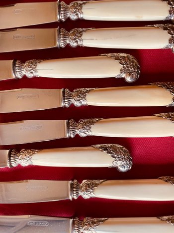 24 table knives with ivory handles and desserts.