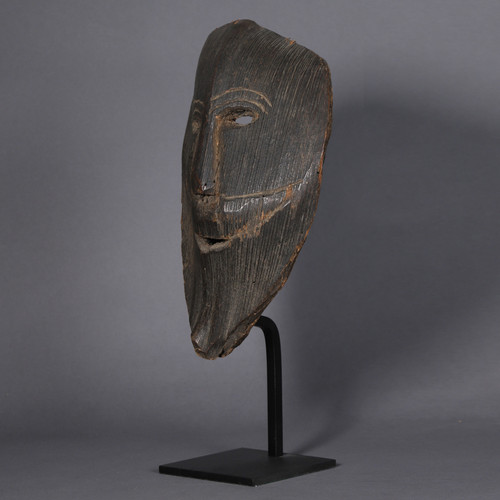 Smiling figure carved from a palm stem – Himalayas