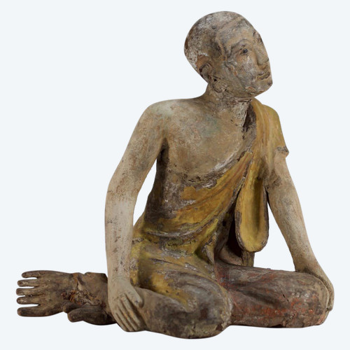 Burmese worshiper in carved wood.