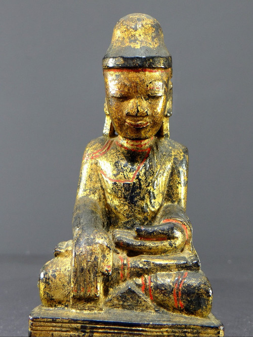 Burma, 19th century, Mandalay Buddha in carved and gilded wood on a black lacquer background.