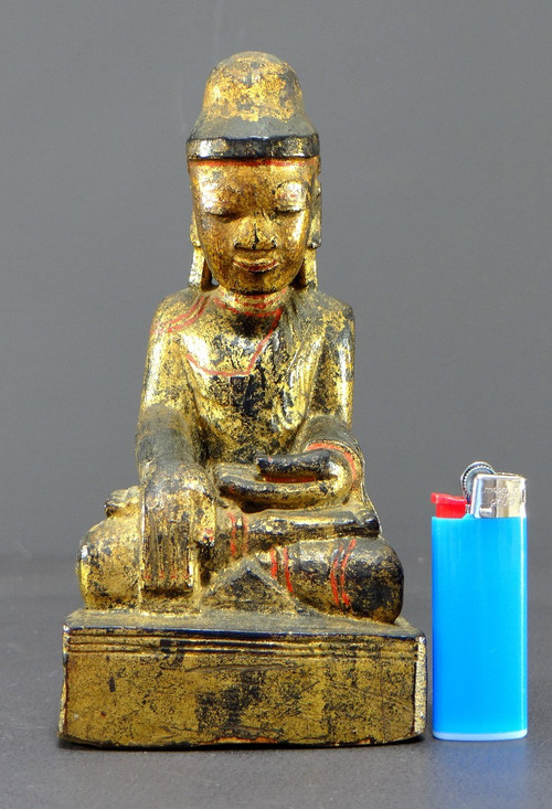 Burma, 19th century, Mandalay Buddha in carved and gilded wood on a black lacquer background.