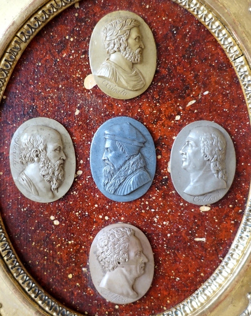 Antique cameos in an Empire frame, souvenir of the Grand Tour on a porphyry background