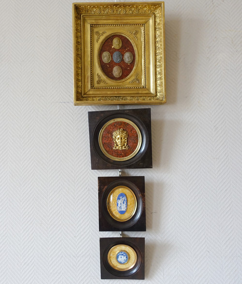 Antique cameos in an Empire frame, souvenir of the Grand Tour on a porphyry background