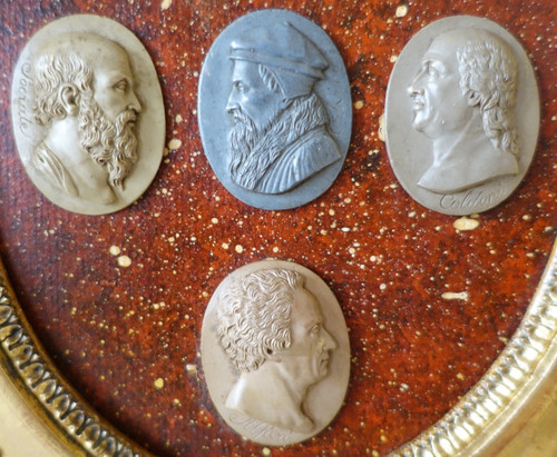 Antique cameos in an Empire frame, souvenir of the Grand Tour on a porphyry background