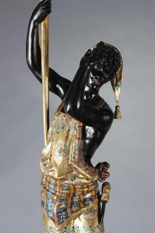 PAIR OF BLACK AND POLYCHROME LACQUERED WOOD TORCHHOLDERS DEPICTING NUBIANS