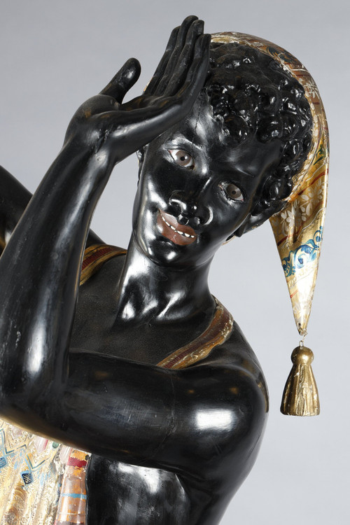 PAIR OF BLACK AND POLYCHROME LACQUERED WOOD TORCHHOLDERS DEPICTING NUBIANS