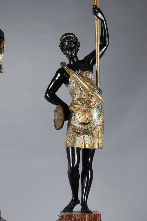 PAIR OF BLACK AND POLYCHROME LACQUERED WOOD TORCHHOLDERS DEPICTING NUBIANS