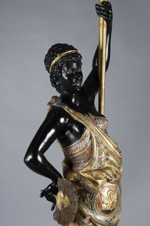 PAIR OF BLACK AND POLYCHROME LACQUERED WOOD TORCHHOLDERS DEPICTING NUBIANS