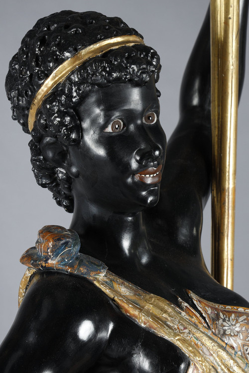 PAIR OF BLACK AND POLYCHROME LACQUERED WOOD TORCHHOLDERS DEPICTING NUBIANS