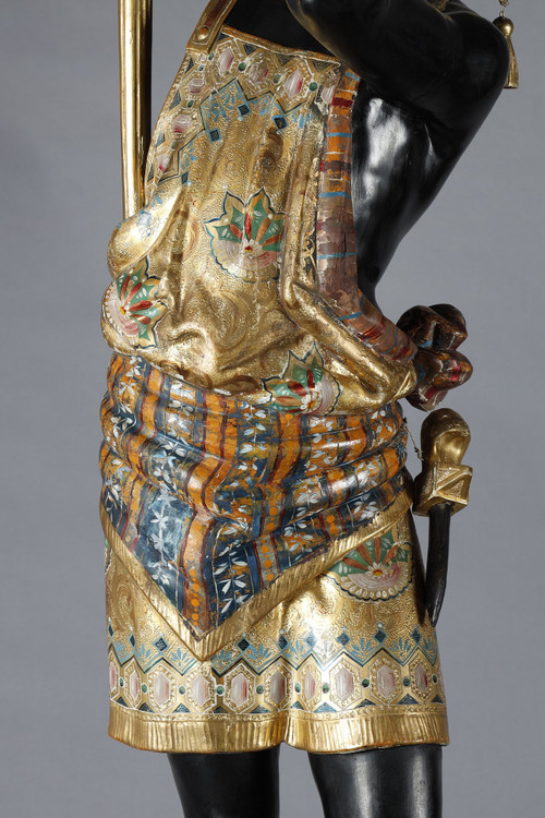 PAIR OF BLACK AND POLYCHROME LACQUERED WOOD TORCHHOLDERS DEPICTING NUBIANS
