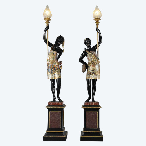 PAIR OF BLACK AND POLYCHROME LACQUERED WOOD TORCHHOLDERS DEPICTING NUBIANS