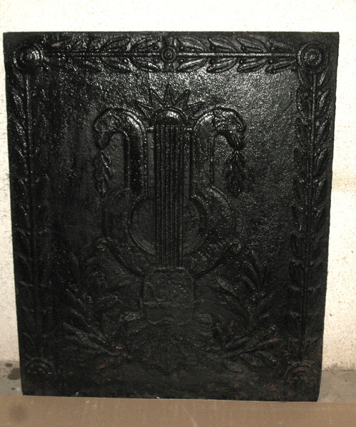 Large cast-iron fireback from the 18th century decorated with coat of arms and lyre