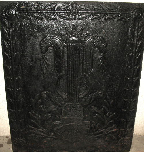Large cast-iron fireback from the 18th century decorated with coat of arms and lyre