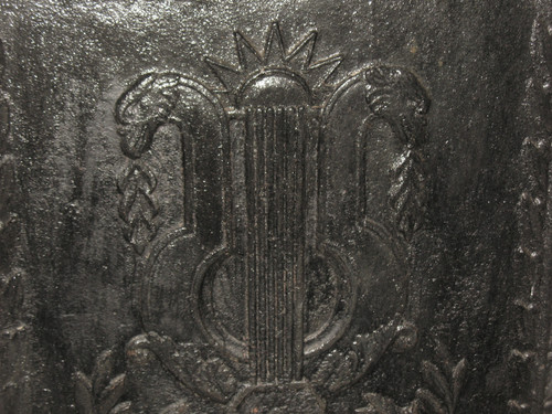 Large cast-iron fireback from the 18th century decorated with coat of arms and lyre