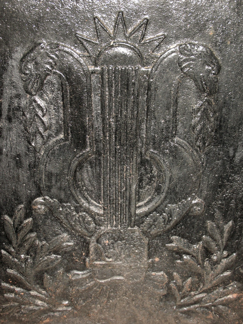 Large cast-iron fireback from the 18th century decorated with coat of arms and lyre