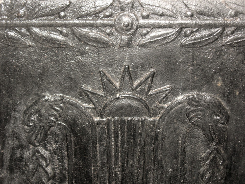 Large cast-iron fireback from the 18th century decorated with coat of arms and lyre