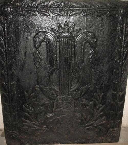 Large cast-iron fireback from the 18th century decorated with coat of arms and lyre