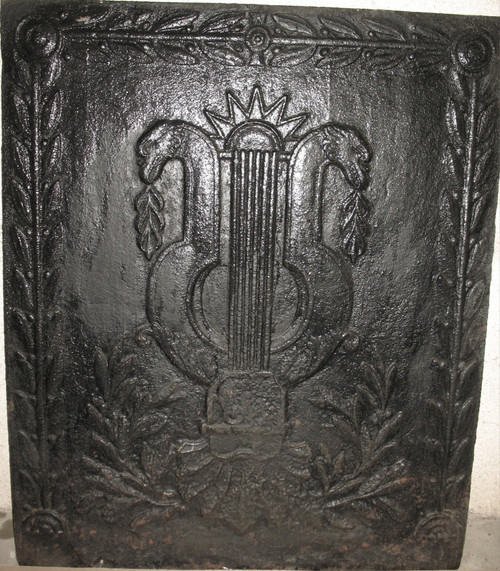 Large cast-iron fireback from the 18th century decorated with coat of arms and lyre