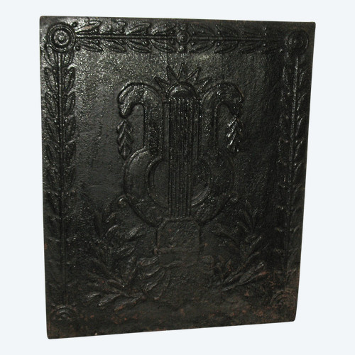 Large cast-iron fireback from the 18th century decorated with coat of arms and lyre