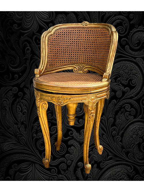 FAUTEUIL TOURNANT COURBÉ EN BOIS DORÉ ET CANNAGE DU XIXe DE STYLE LOUIS XV