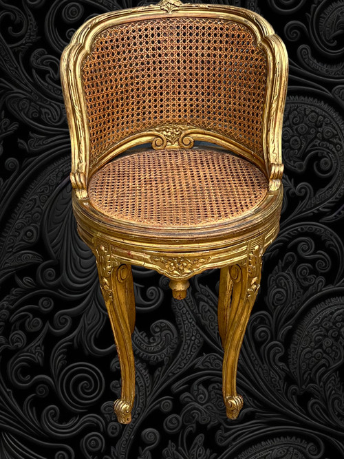 FAUTEUIL TOURNANT COURBÉ EN BOIS DORÉ ET CANNAGE DU XIXe DE STYLE LOUIS XV