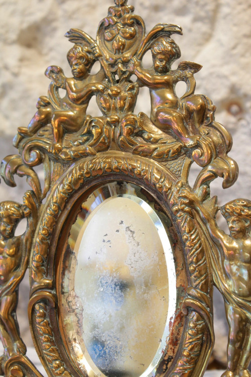Specchio in bronzo decorato con putti e mascaroni fine XIX secolo