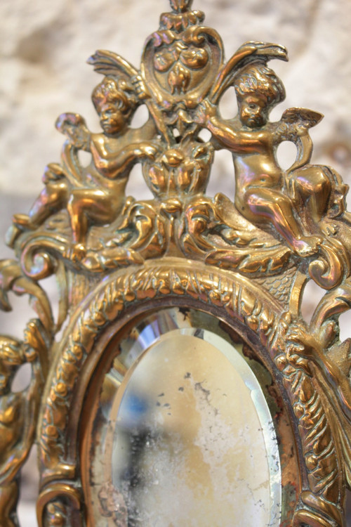 Specchio in bronzo decorato con putti e mascaroni fine XIX secolo
