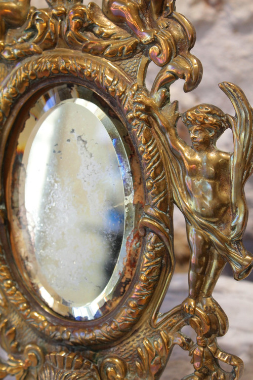 Specchio in bronzo decorato con putti e mascaroni fine XIX secolo