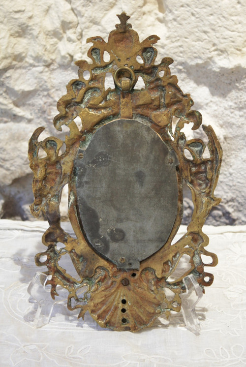 Specchio in bronzo decorato con putti e mascaroni fine XIX secolo