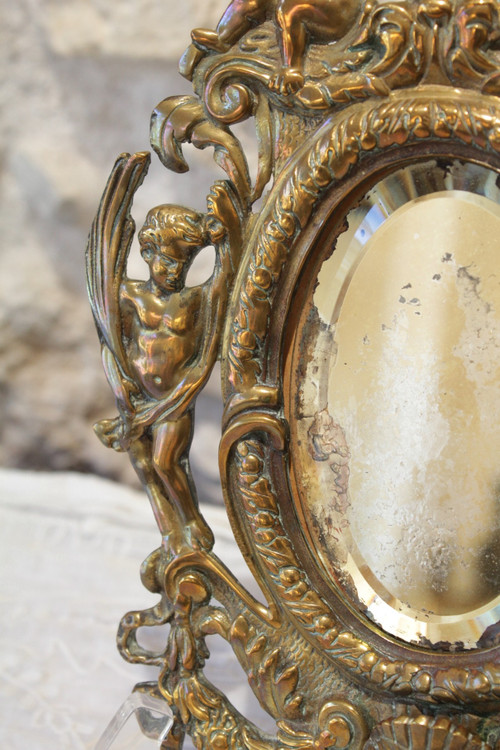 Specchio in bronzo decorato con putti e mascaroni fine XIX secolo
