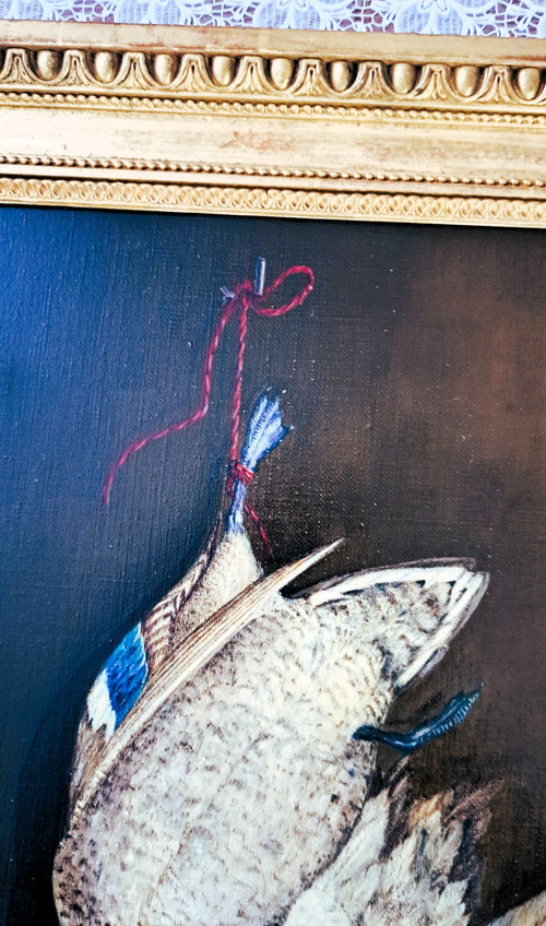 Scene de retour de chasse un canard attaché par la patte